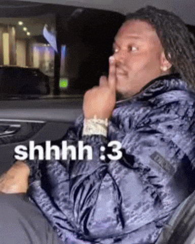 a man with dreadlocks is sitting in a car with his finger on his lips and the words shhhh : 3 above him