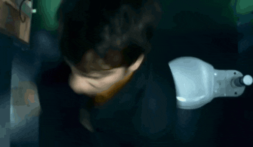 a blurry picture of a person laying on their back with their eyes closed