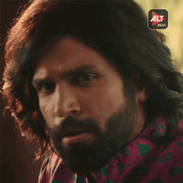 a close up of a man 's face with the alt balaji app on the bottom right