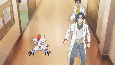 a man in a lab coat is walking down a hallway
