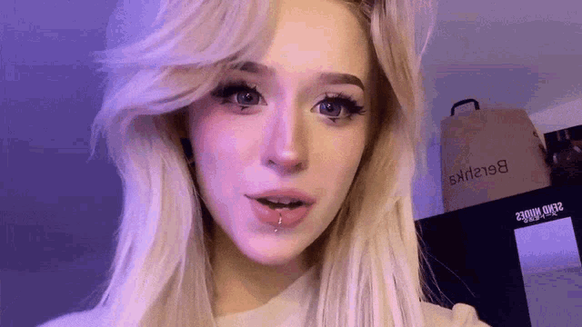 a blonde woman with a piercing in her lip