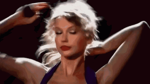 a close up of a woman 's face with her arms outstretched and her hair in a ponytail .