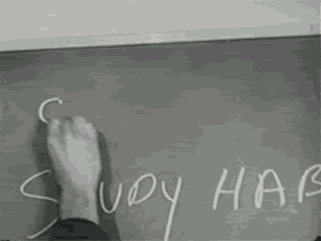 a black and white photo of a man writing on a chalkboard that says study