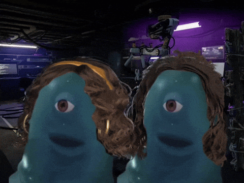 a couple of blue faces with red eyes are in a dark room
