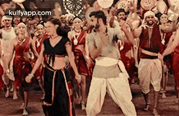 a man and a woman are dancing together in front of a crowd of people .