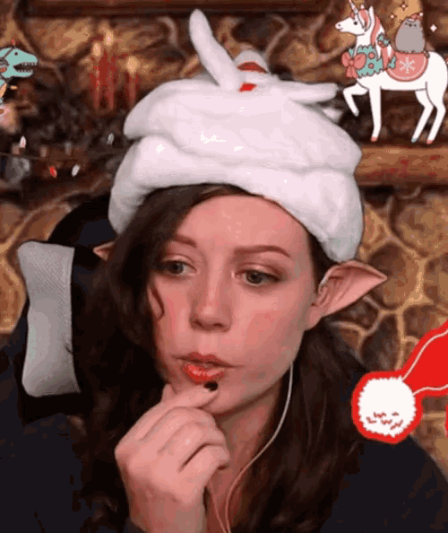 a woman wearing a bunny hat with a unicorn on it