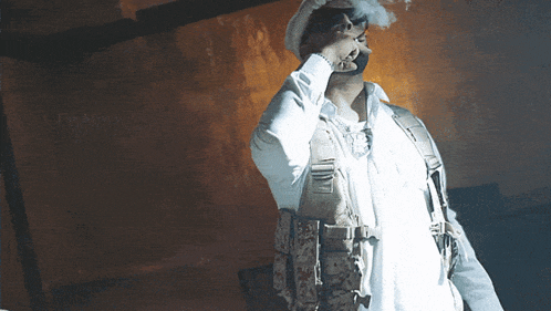 a man in a military uniform is smoking a cigarette in a dark room