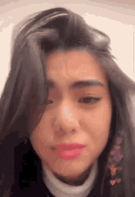 a close up of a woman 's face with a tear coming out of her eyes .