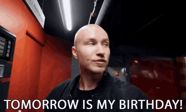 a bald man says " tomorrow is my birthday " in a dark room