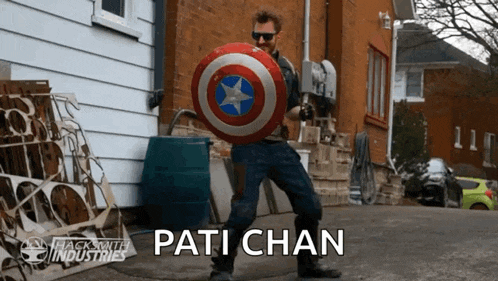 a man in a captain america costume is holding a shield and the name pati chan is on the bottom right