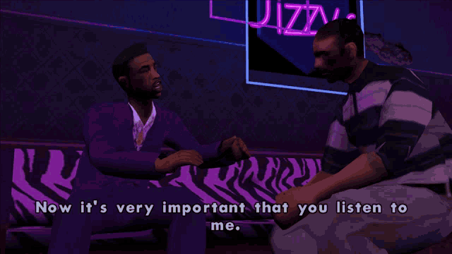 two men are sitting on a zebra print couch and one of them is saying now it 's very important that you listen to me