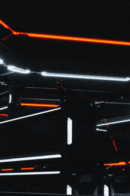 a dark background with red and white lights and the word hyperwax