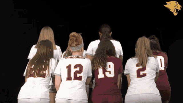 the number 12 is on the back of the jersey of a female athlete