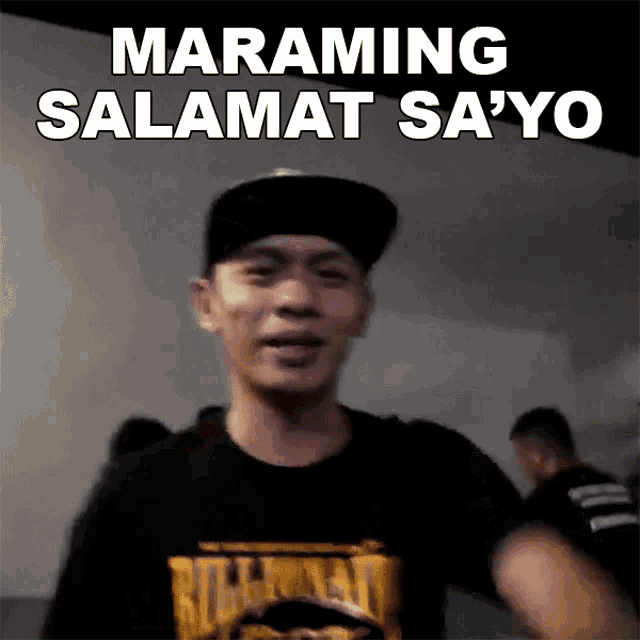 a man wearing a baseball cap and a black shirt says " maraming salamat sayo "