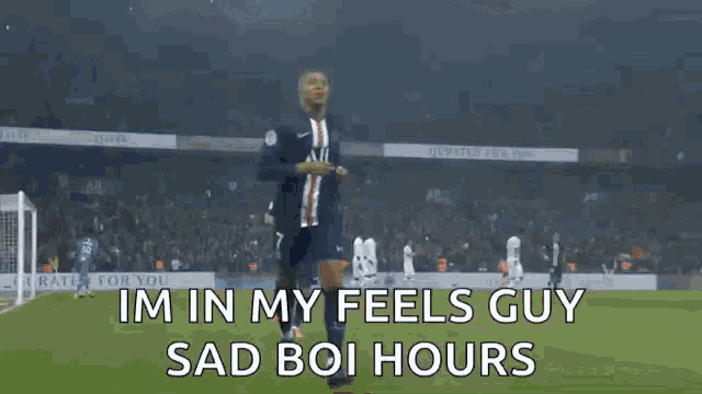 a soccer player is celebrating a goal on a soccer field with the words i 'm in my feels guy sad boi hours