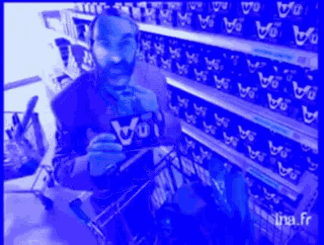 a man in a shopping cart is looking at a box of voi