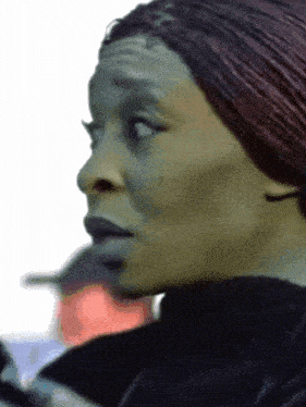 a close up of a woman 's face with a surprised expression