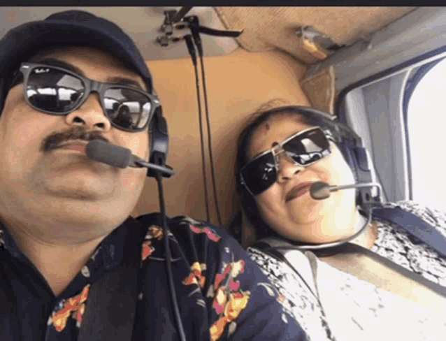 a man and woman wearing sunglasses and headphones