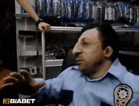a man in a police uniform is talking to a woman