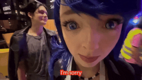 a woman with blue hair says i 'm sorry in front of a man