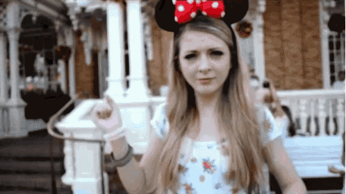 a woman wearing a headband with minnie mouse ears on