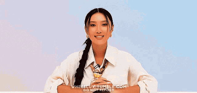 a woman in a white shirt and tie is giving the peace sign