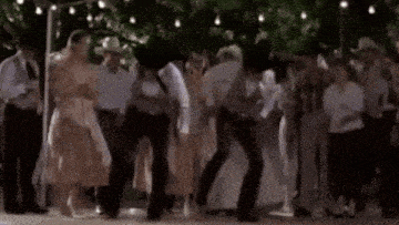 a group of people are dancing at a wedding reception while wearing cowboy hats .