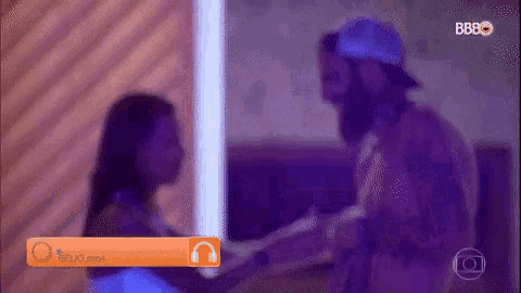 a man and a woman are standing next to each other and holding hands .
