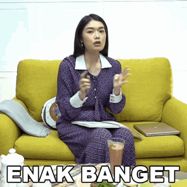 a woman is sitting on a yellow couch with the words enak banget written on the bottom