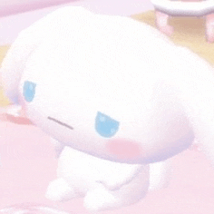 a close up of a white stuffed animal with blue eyes on a pink surface .