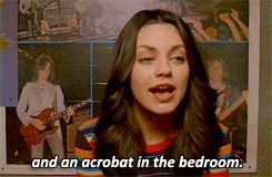 a woman says " and an acrobat in the bedroom " in front of a picture of a man playing a guitar