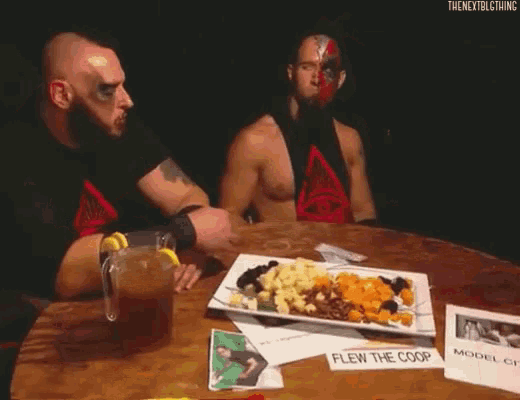 a man sitting at a table with a plate of food in front of him that says the nextbigthing on it