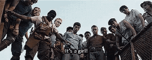 a group of young men are standing next to each other in a circle and one of them is holding a baby .