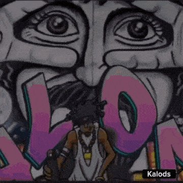 a close up of a graffiti wall with a man holding a skateboard in front of a large face .