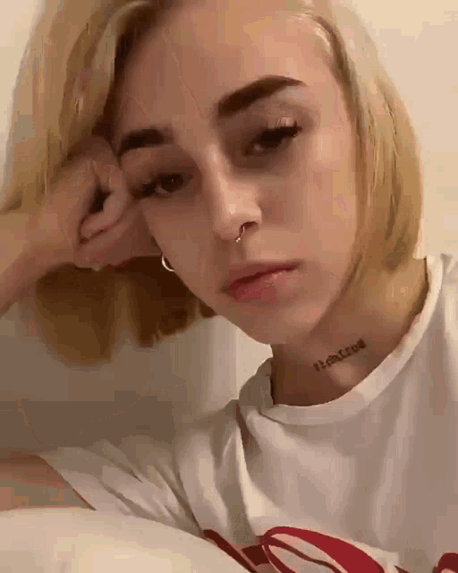 a young woman with a tattoo on her neck that says 11 on it