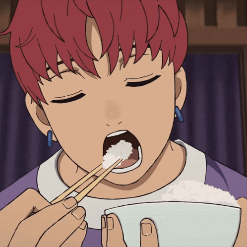 a man with red hair is eating rice with chopsticks
