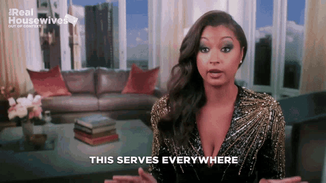 a woman says " this serves everywhere " while standing in front of a living room