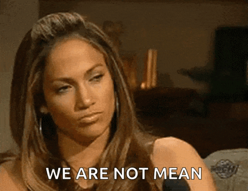 a woman says " we are not mean " while sitting in front of a microphone