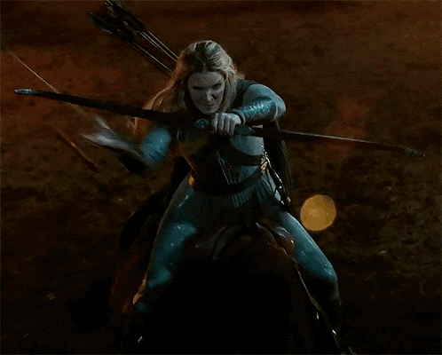 a woman in a blue costume is holding a bow and arrow