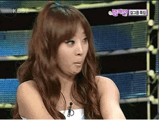 a woman with long hair is making a funny face