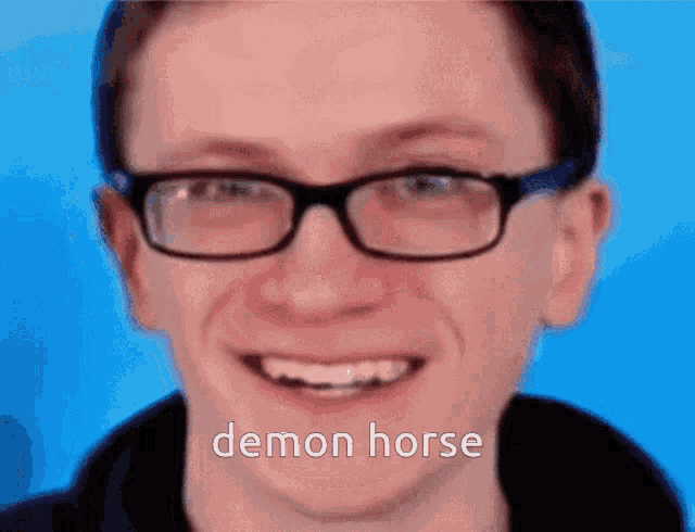 a close up of a man wearing glasses with the words demon horse written on his face