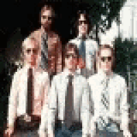 a group of men in suits and ties are posing for a photo .