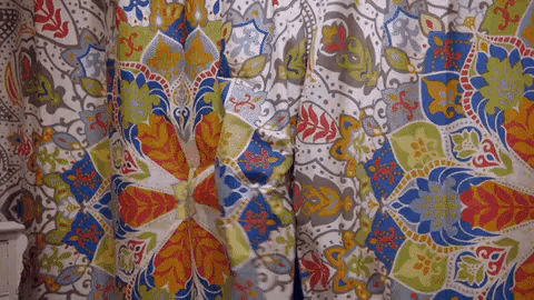 a close up of a curtain with a floral pattern on it