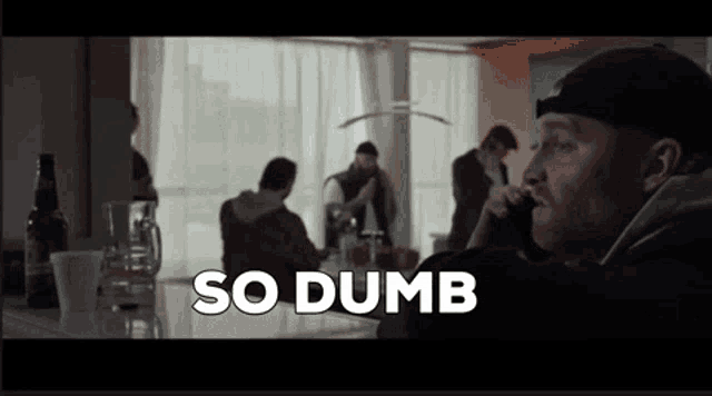 a man talking on a cell phone with the words so dumb written above him