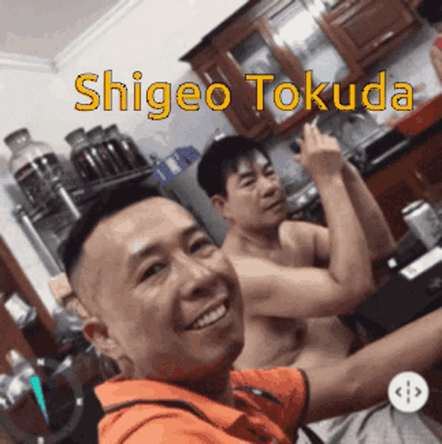 two shirtless men are posing for a picture with the name shigeo tokuda written above them
