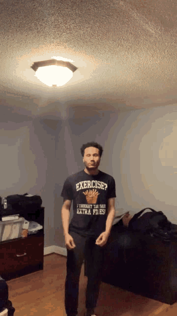 a man in a black shirt that says exercise