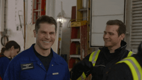 a man in a blue uniform has a patch on his jacket that says ' land and aviation services '