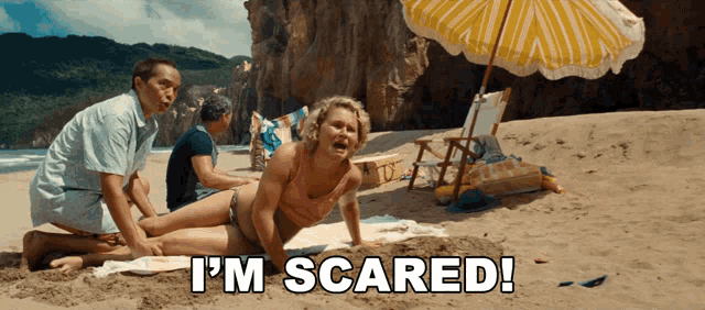 a woman laying on the beach with the words i 'm scared written below her