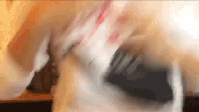 a close up of a person 's face with a blurred background .