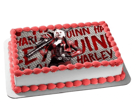 a cake with a picture of harley quinn holding a gun